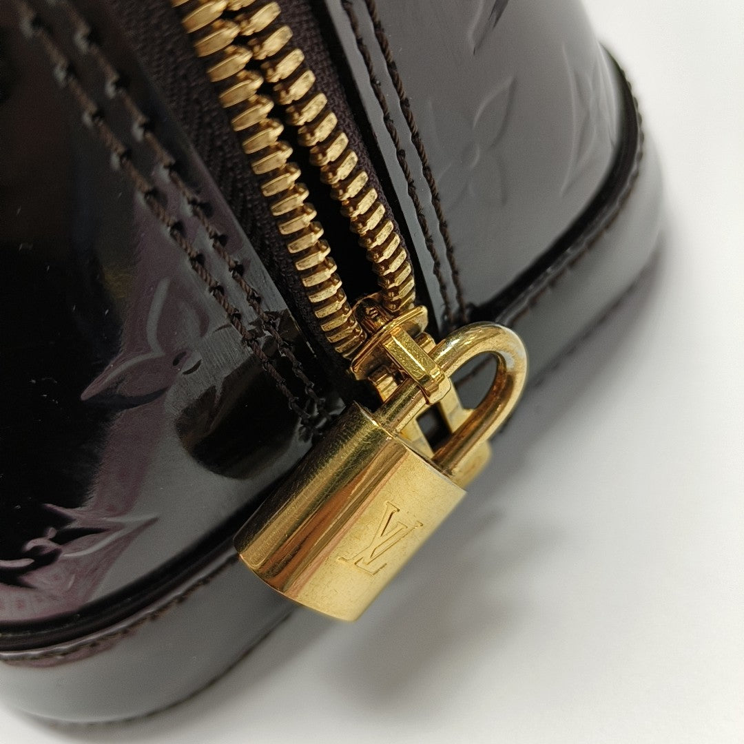 Authenticated pre-owned  Alma PM Monogram Patent Leather Brown - Top Handle Bag at Looply