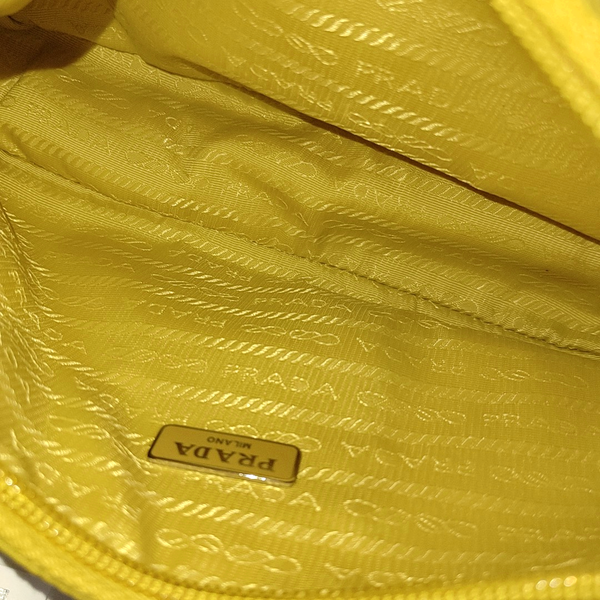 Authenticated pre-owned  Re-Edition2000 Mini Nylon Yellow - Top Handle Bag at Looply