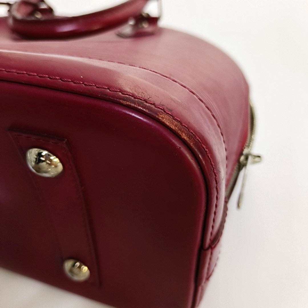 Authenticated pre-owned  Alma PM Epi Burgundy - Top Handle Bag at Looply