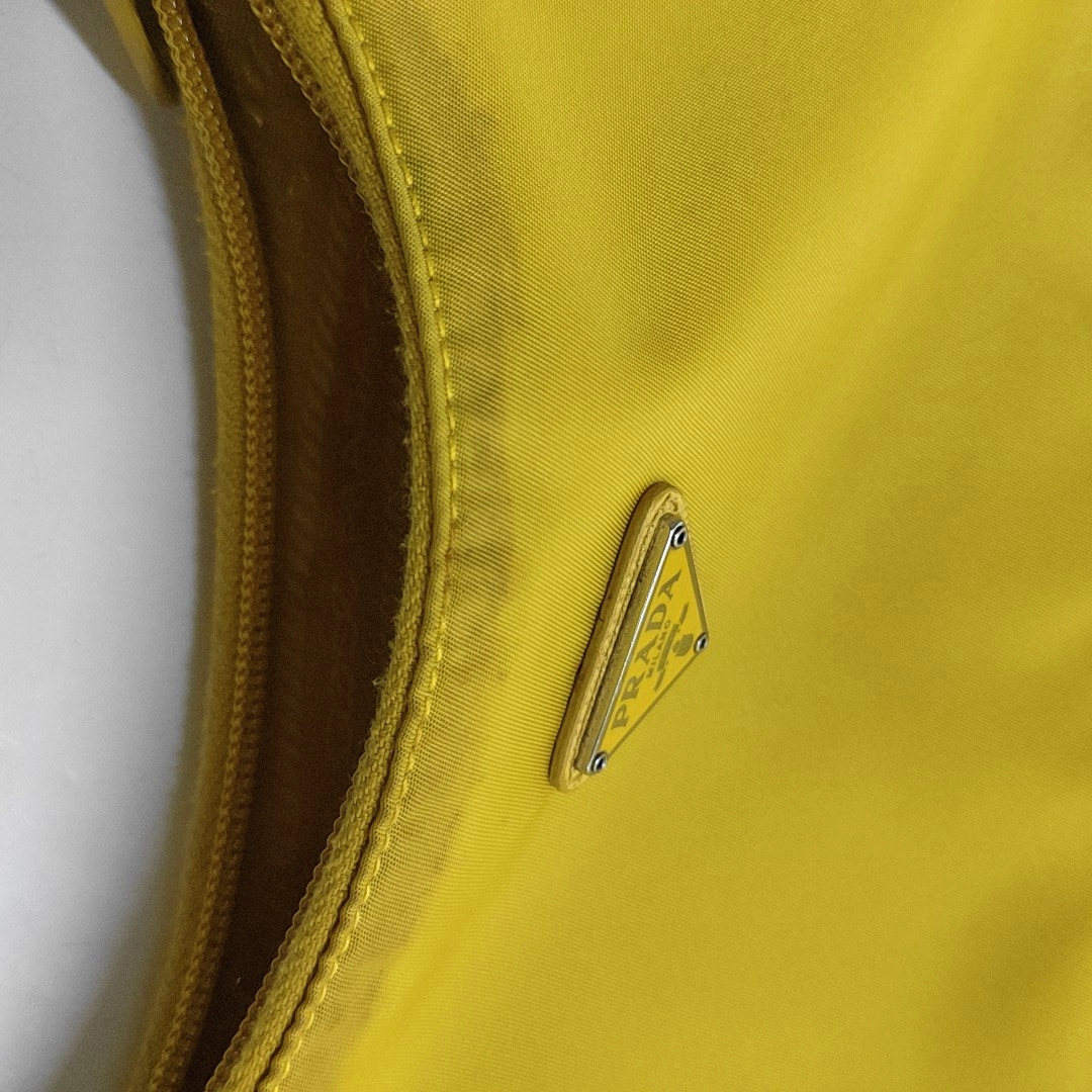 Authenticated pre-owned  Re-Edition2000 Mini Nylon Yellow - Top Handle Bag at Looply