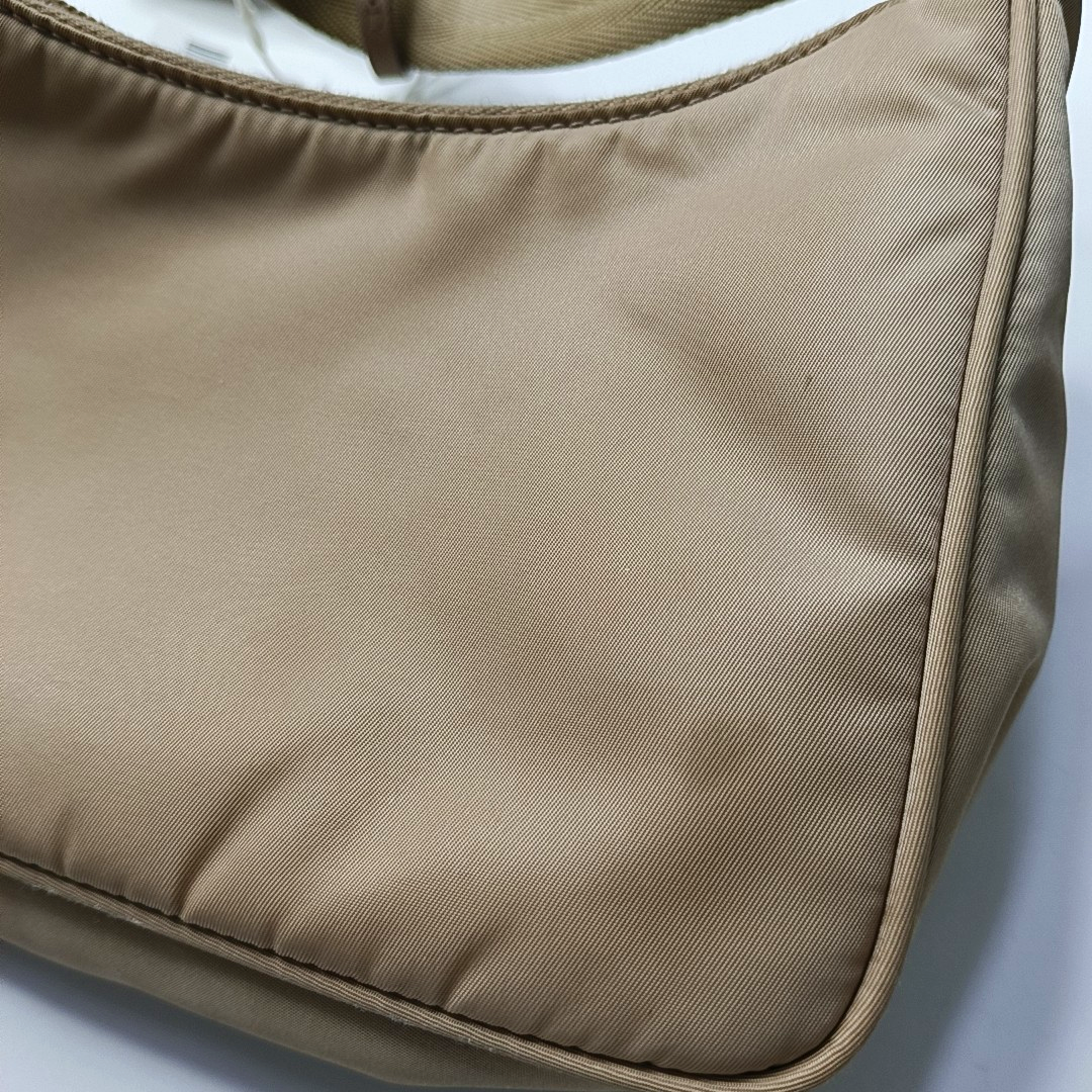 Authenticated pre-owned  Re-edition2000 Mini Nylon Beige - Top Handle Bag at Looply
