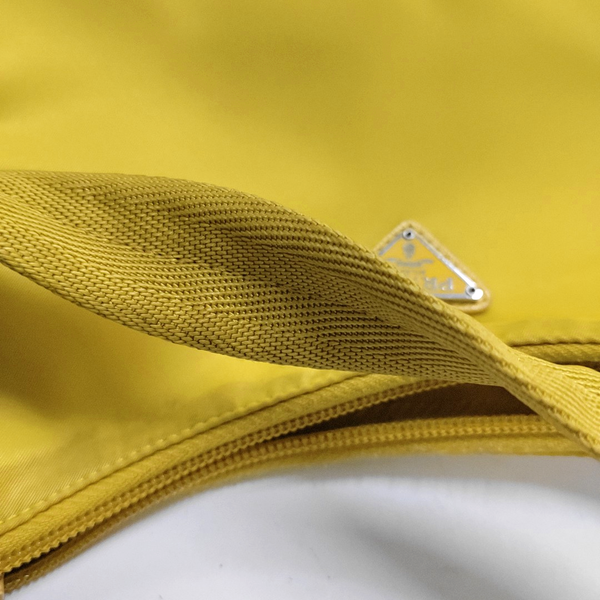 Authenticated pre-owned  Re-Edition2000 Mini Nylon Yellow - Top Handle Bag at Looply