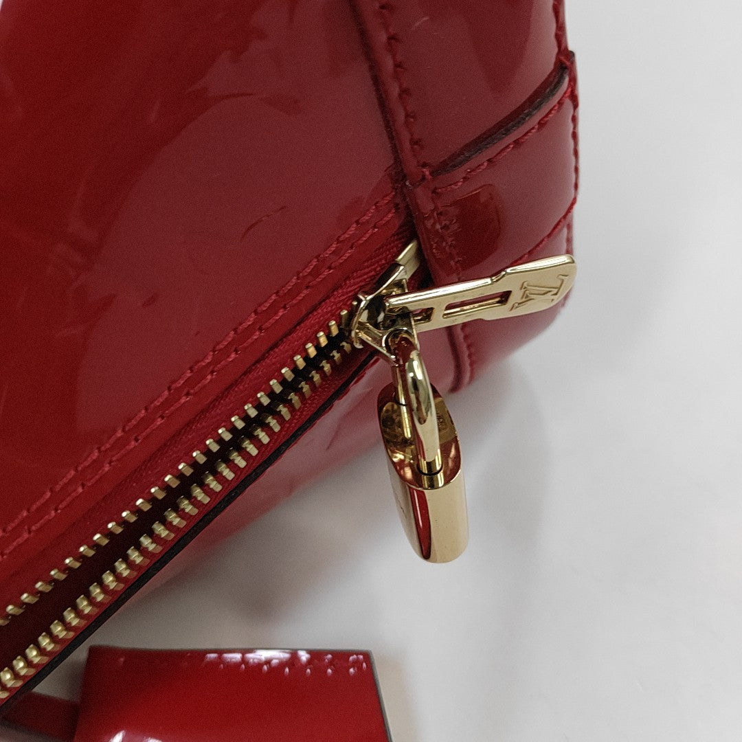 Authenticated pre-owned  Alma PM Monogram Patent Leather Red - Top Handle Bag at Looply