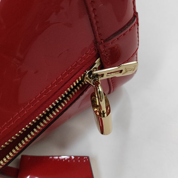 Authenticated pre-owned  Alma PM Monogram Patent Leather Red - Top Handle Bag at Looply