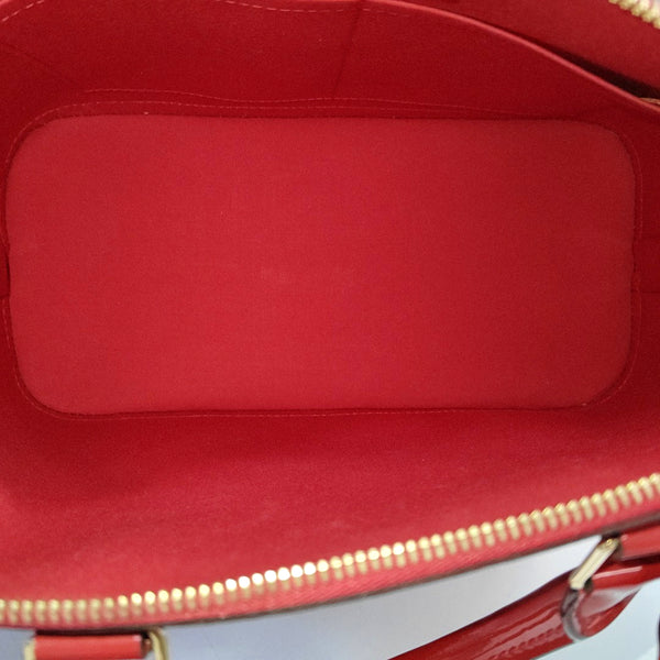 Authenticated pre-owned  Alma PM Monogram Patent Leather Red - Top Handle Bag at Looply
