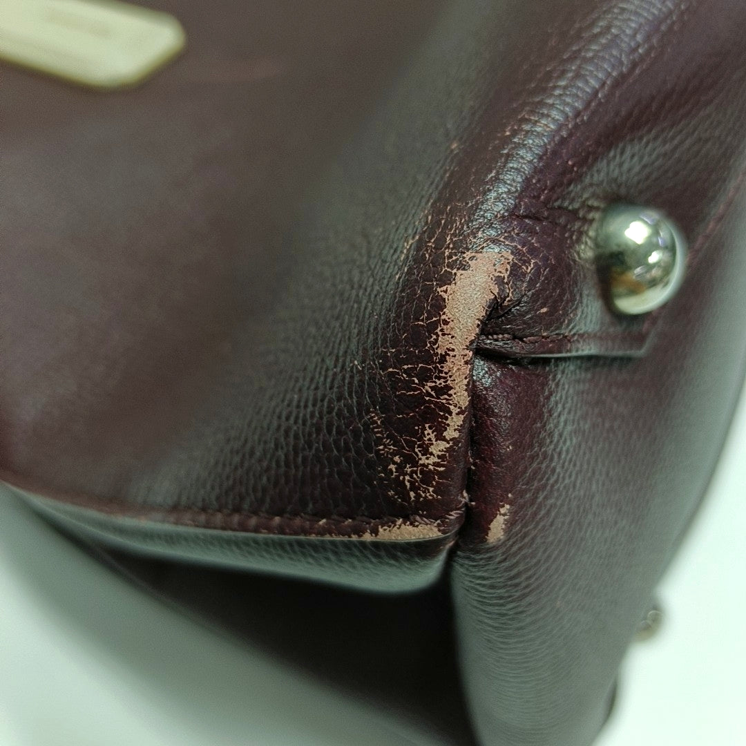 Authenticated pre-owned  The Banner Medium Calfskin Burgundy - Top Handle Bag at Looply