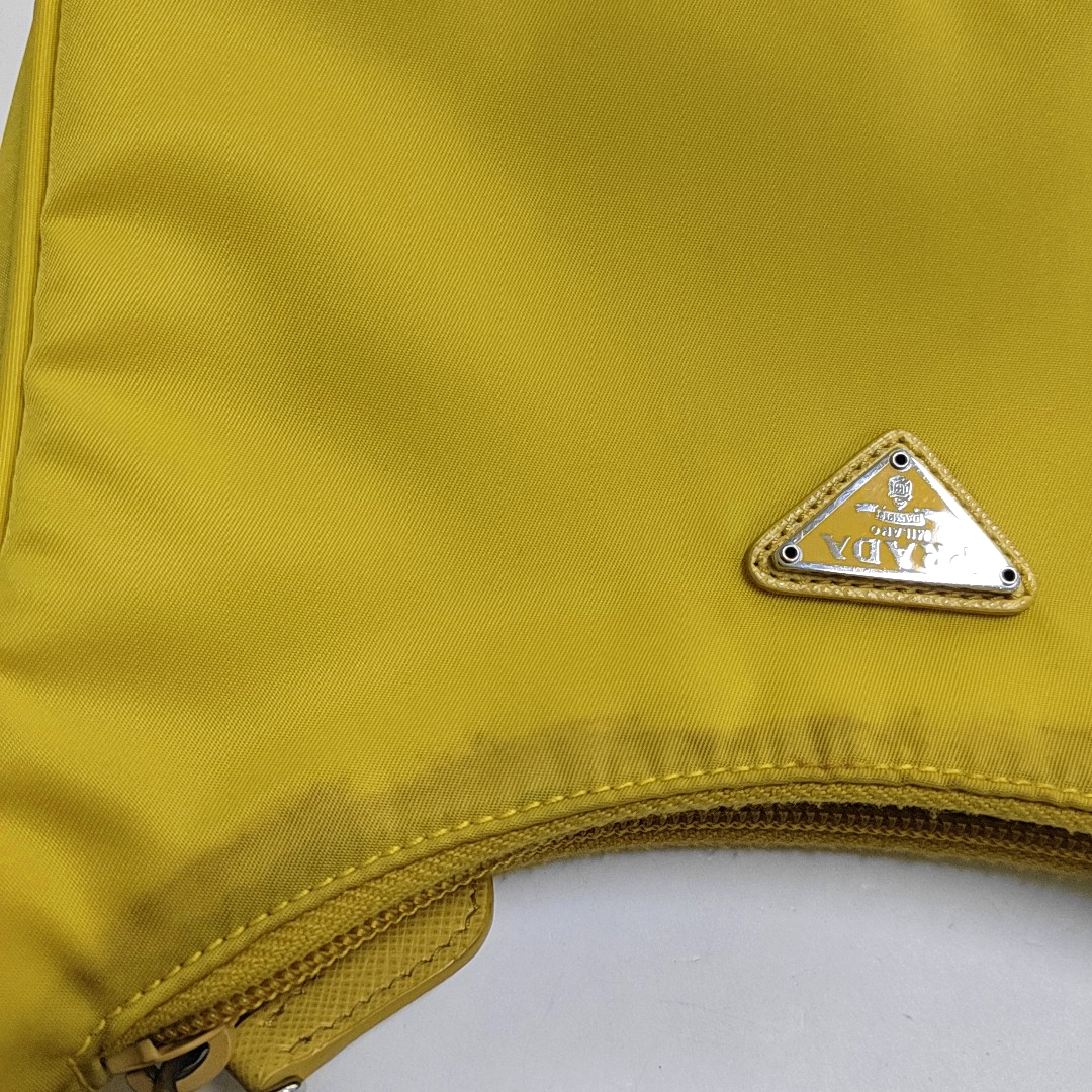 Authenticated pre-owned  Re-Edition2000 Mini Nylon Yellow - Top Handle Bag at Looply