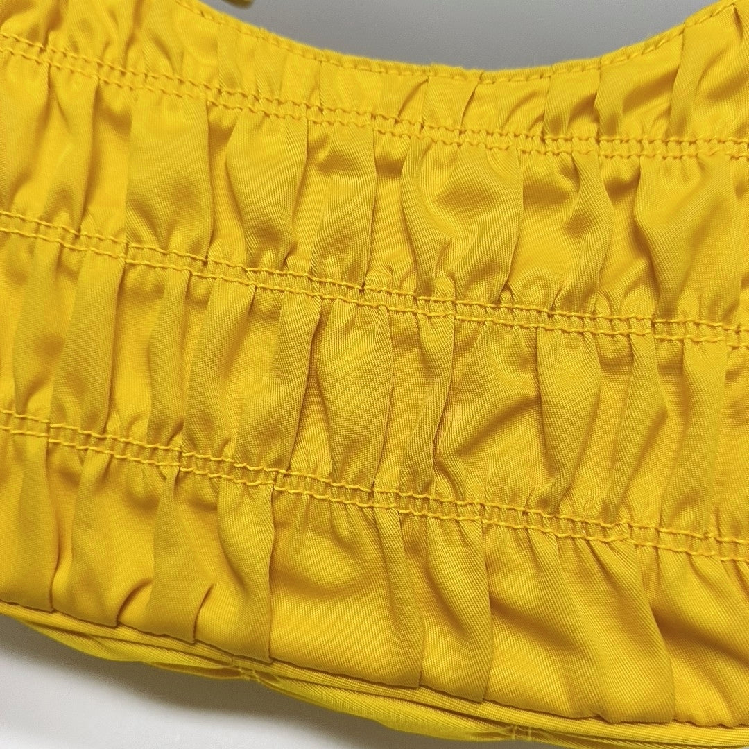 Authenticated pre-owned  Re-edition2005 Mini Nylon Yellow - Top Handle Bag at Looply