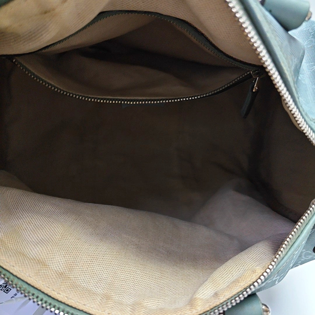 Authenticated pre-owned  Joy Medium Monogram Coated Canvas Blue - Top Handle Bag at Looply
