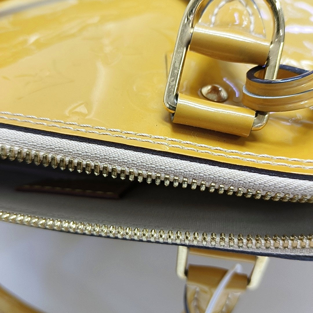 Authenticated pre-owned  Alma PM Monogram Patent Leather Yellow - Top Handle Bag at Looply